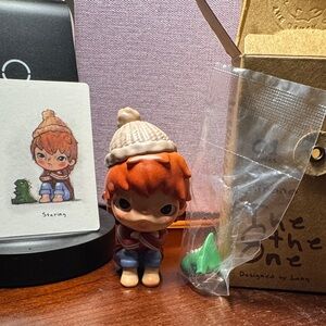 Cute Red-Haired Toy Figure with Green Accessory